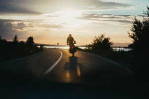 motorcycle on road by water