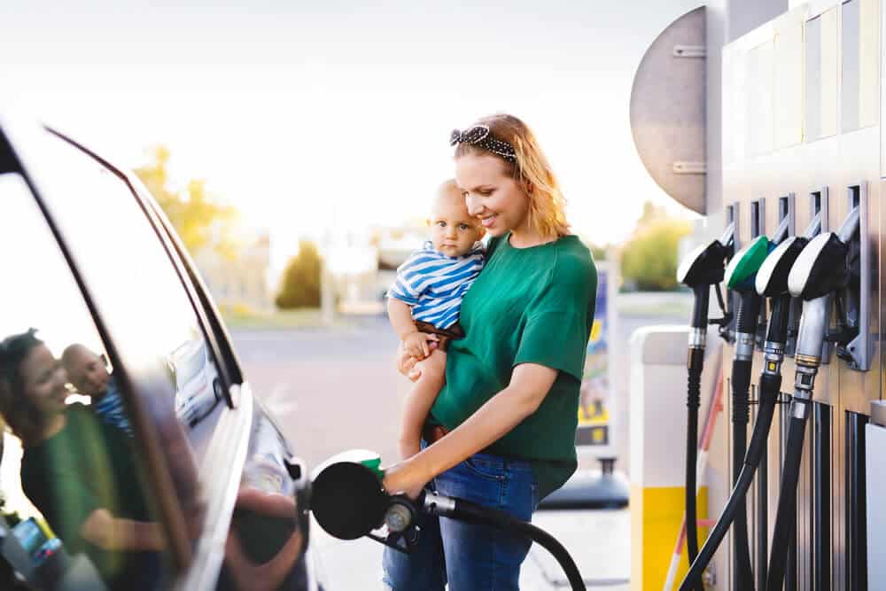 A mother and her child refueling her vehicle for a Georgia roadtrip
